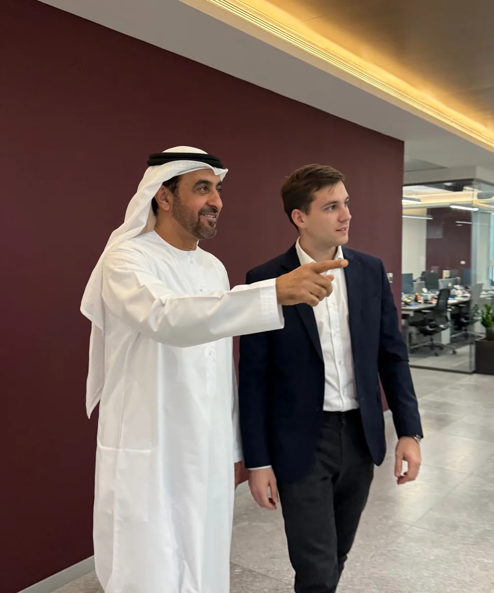 Emirati mentor showing a new colleague around the office on his first day